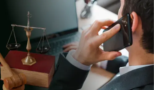 Businessman On Phone With Legal Symbols, Illustrating Call Recording Compliance.