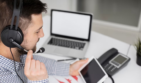 Picture of man testing his microphone with other various gadget.