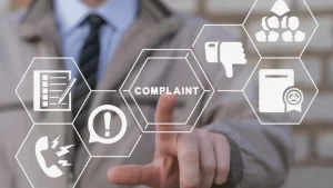Hand pointing at virtual complaint interface with icons around it