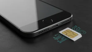 Smartphone with SIM card on black surface, mobile technology concept.