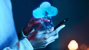 A person holding a phone with a glowing cloud displayed on the screen, their finger gently touching the screen.