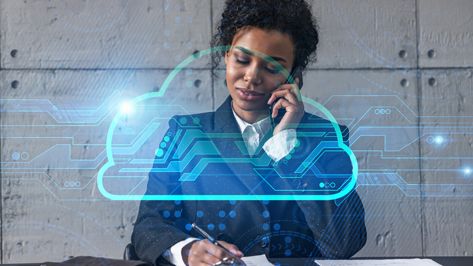 A women in a formal suite speaking on the phone while writing on the notepad and a digital cloud icon is displayed.